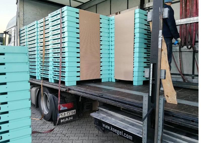 Finished steel pallets loaded onto a truck