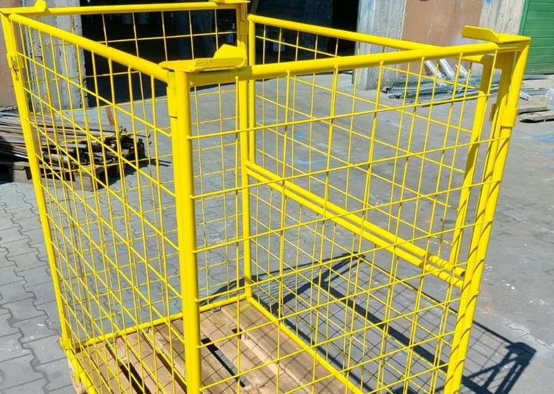 Yellow powder-coated mesh container on a timber pallet